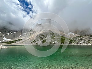 View of Mount Redentore covered by cloud and Pilato lake in the park of Monti Sibillini