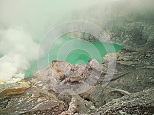 The view of mountain crater cliffs emit sulfur fumes