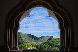 View of the mountain and forest in Vianden, Luxembourg, from an arch inside the Vianden Castle