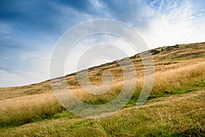 View of mountain and grass with blue sky