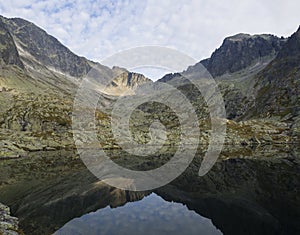 Pohľad na horské pleso Prostredné spišské pleso vysoké tatry na slovensku s horským hrebeňom nd modrou oblohou odrážajúcou sa v