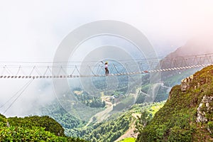 View of the mountain landscape gorge, tourist human walking along an extreme staircase over a precipice