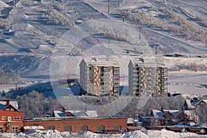 View of the mountain Loussavaara and the newly built housing next to it on a sunny winter day. Kiruna in Swedish Lapland