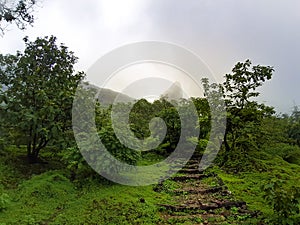 View of Mountain peak of Naneghat with stairs of gravels & soil in the foreground