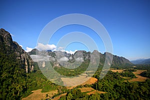 View at a mountain range with morning fog in a mountain valley