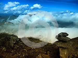 View from mountain range to the valley above fog and clouds