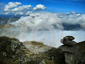 View from mountain range to the valley above fog and clouds