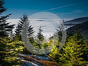 View from mountain range to the valley above fog and clouds