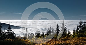 View from mountain range to the valley above fog and clouds