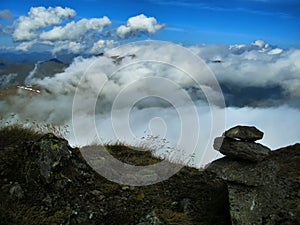 View from mountain range to the valley above fog and clouds