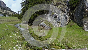 View of mountain rivulet flowing between huge stones, Dolomites, landscape