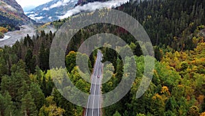 view of the mountain road in the autumn mountains of Dombai, the car is driving along the road