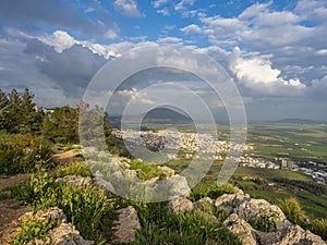 View from the mountain to the green valley on a cloudy spring day.