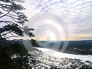 View from the mountain to nature and settlement on a winter day