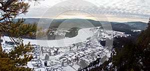 View from the mountain to nature and settlement on a winter day