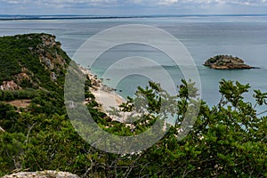 View from mountain top to cliff and island on Creiro beach on a cloudy day - ArrÃÂ¡bida Mountain Natural Park, SetÃÂºbal - Portugal photo