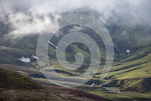 View mountain valley with green, foggy hills. Laugavegur hiking trail, Iceland