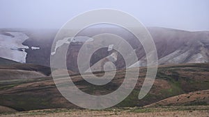 View mountain valley with green, foggy hills. Laugavegur hiking trail, Iceland