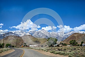 View of Mountain Whitney with a curved empty road