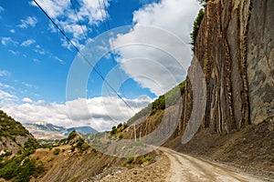 View of mountains Babadag and a muddy road along the river Girdimanchay Lahij yolu from the side in Lahic village, Azerbaijan