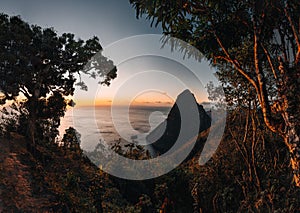 A view of the mountains from Petit and Gros Piton on Saint Lucia in the Caribbean under blue skies during sunset. Photo