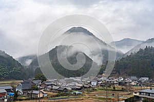 View of mountains and rural scene in foggy weather, Japanese country landscape