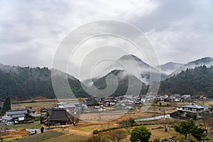 View of mountains and rural scene in foggy weather, Japanese country landscape