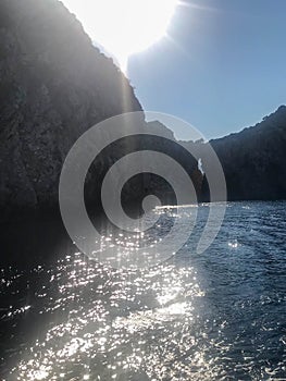 View of mountains and water in the sea and ocean in nature on a very sunny day. Landscape