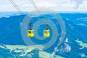 View of mountains and yellow Seilbahn cable car gondolas from Zwolferhorn mountain