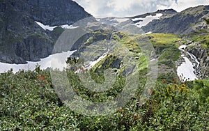 view of the mountainside with glaciers and waterfalls