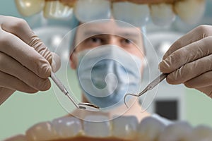 View from mouth on dentist with dental instruments
