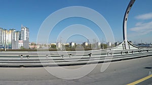 View from the moving car on the modern speedway with portly signs and signs with names of streets in Russian