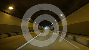 View from a moving car, underground high-speed tunnel