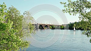 view moving fishing sailing motor boat on Dnipro river at sunrise sunset. landscape of industrial bridge over lake in