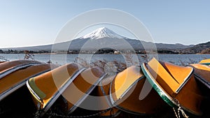 View of Mt. Fuji or Fuji-san with yellow boat and clear sky at lake kawaguchiko, Japan
