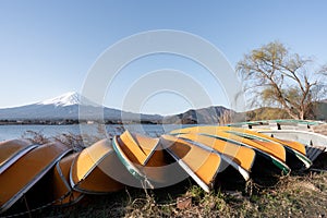 View of Mt. Fuji or Fuji-san with yellow boat and clear sky at lake kawaguchiko, Japan