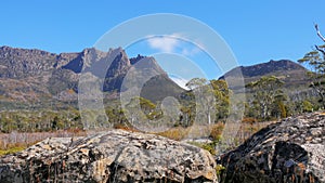 The view of mt ossa rom the overland track with dolerite boulders in the foreground photo