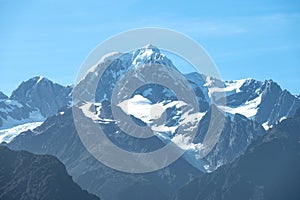 The view of Mt. Tasman peak, one of the famous landmark, near Mt. Cook in a fresh sunny day under blue sky, West Coast, New