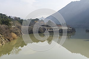 View of the Mtkvari (Kura) river and Jvari monastery from the bridge in the city of Mtskheta. Reflection of the sky