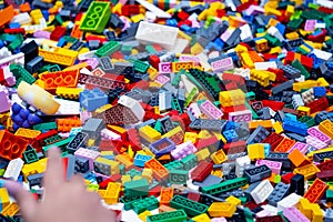 View on multi color plastic bricks at the table.