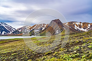 View of multicolored mountain with volcanic lake