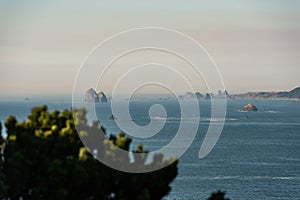 View of multiple Islets that stand out in the Pacific Ocean amid the haze in Southern Oregon, USA