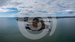 View of the Mumbles headland with the historic lighthouse and piers in Swansea Bay