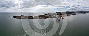 View of the Mumbles headland with the historic lighthouse and piers in Swansea Bay