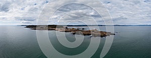 View of the Mumbles headland with the historic lighthouse and piers in Swansea Bay