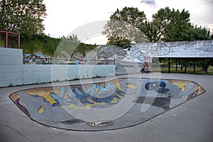 Murales and skateboard track on urban park photo