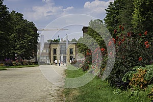 View of Museum Kunstpalast at the end of a pathway lined with fl