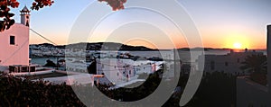 view of Mykonos, windmill and old port from a house at sunset