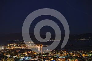 View of Nafplio town and harbour from Prophet Helias or Profitis Ilias hill at night. Argolis, Peloponnese, Greece