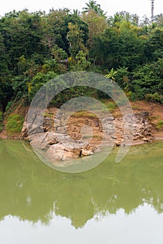 View of the Nam Khan river, Louangphabang, Laos. Copy space for text. Vertical.